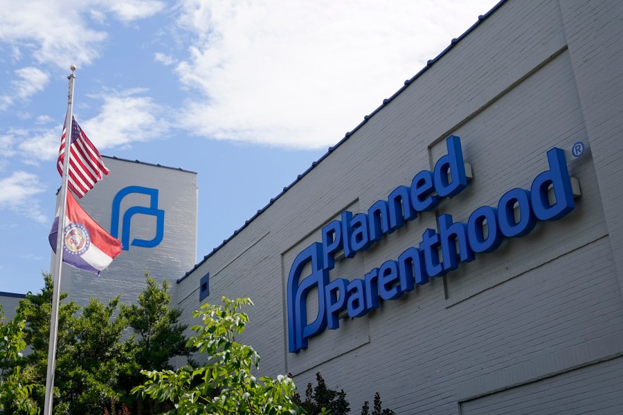 American and Missouri state flags are seen flying outside a Planned Parenthood building.