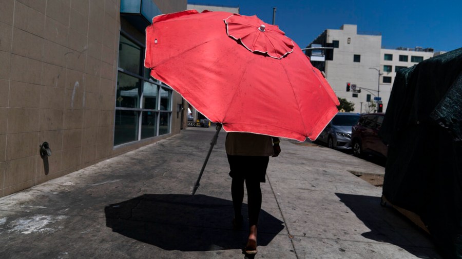 Woman walks with umbrella