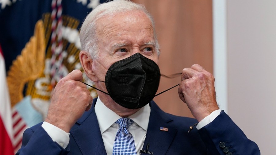 President Joe Biden removes his face mask as he arrives to speak about the economy during a meeting with CEOs in the South Court Auditorium on the White House complex in Washington, Thursday, July 28, 2022.