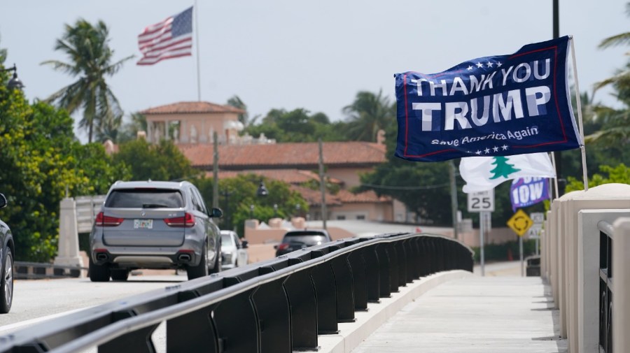 A flag flies in the air near former President Donald Trump's Mar-a-Lago estate.