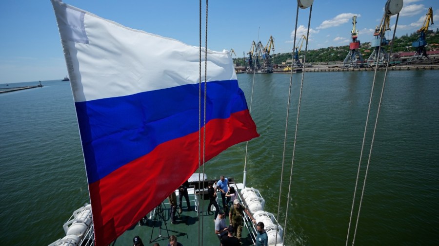 A Russian national flag flies over the Mariupol Sea Port