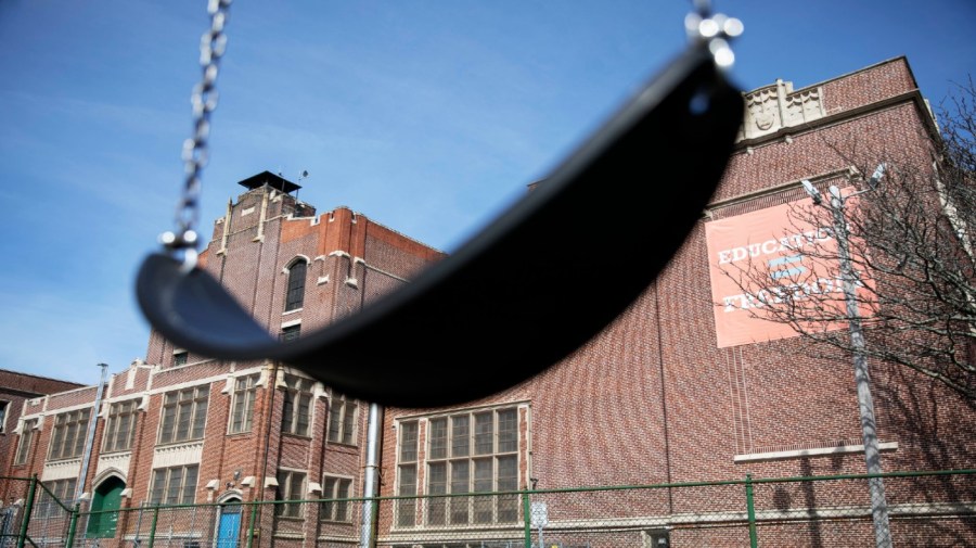 FILE - A swing sits empty on a playground outside in Providence, R.I., March 7, 2020.