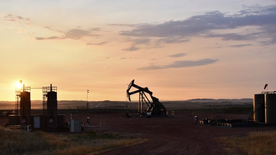 An oil well works at sunrise.