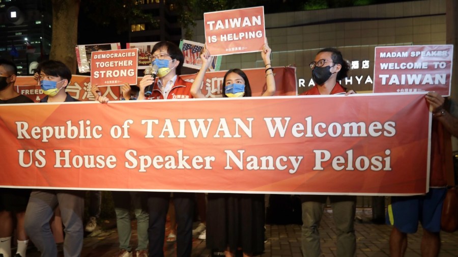 Supporters hold a banner outside the hotel where U.S. House Speaker Nancy Pelosi is supposed to be staying in Taipei, Taiwan, Tuesday, Aug 2, 2022.