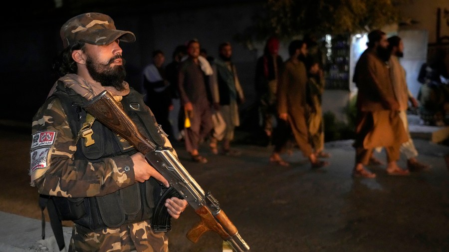 A Taliban fighter stands guard