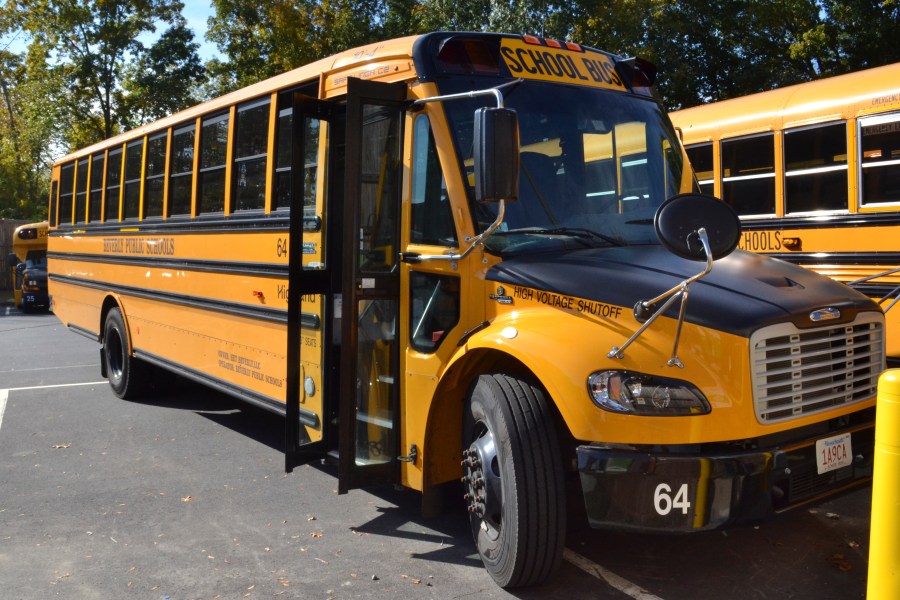 An electric school bus, leased by Beverly Public Schools in Beverly, Mass., rests in a bus yard on Oct. 21, 2021.