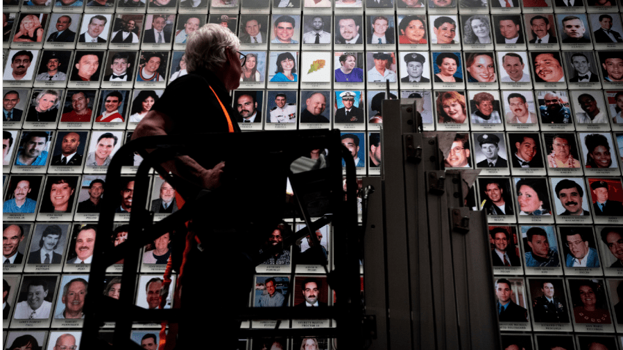 Randolph Black replaces a oak leaf picture with a portrait of Antonio Dorsey Pratt in the 9/11 Memorial & Museum on Wednesday, June 29, 2022 in New York.