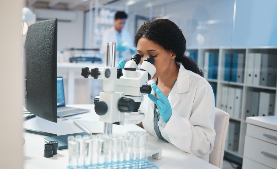 Woman looking through microscope.