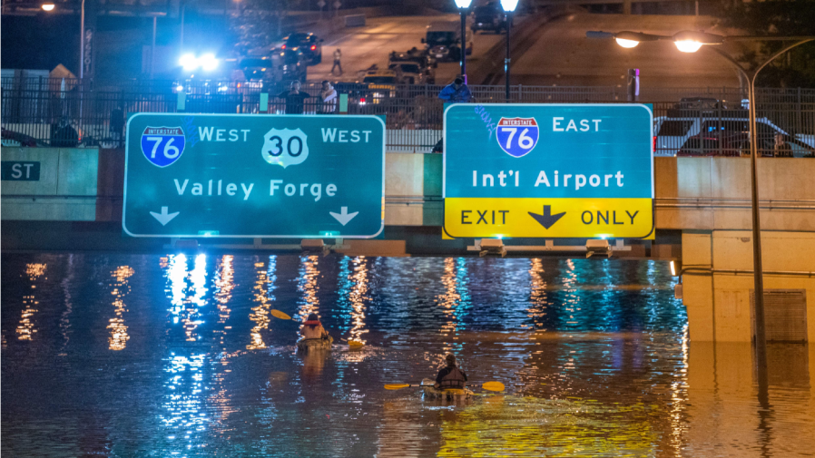 TOPSHOT - Kayakers paddle down a portion of Interstate 676 after flooding from heavy rains from hurricane Ida in Philadelphia, Pennsylvania on September 2, 2021.