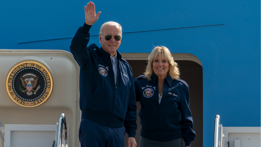 U.S. President Joe Biden waves as first lady Jill Biden watches standing at the top of the steps of Air Force One before boarding at Andrews Air Force Base, Md., Saturday, Sept. 17, 2022.