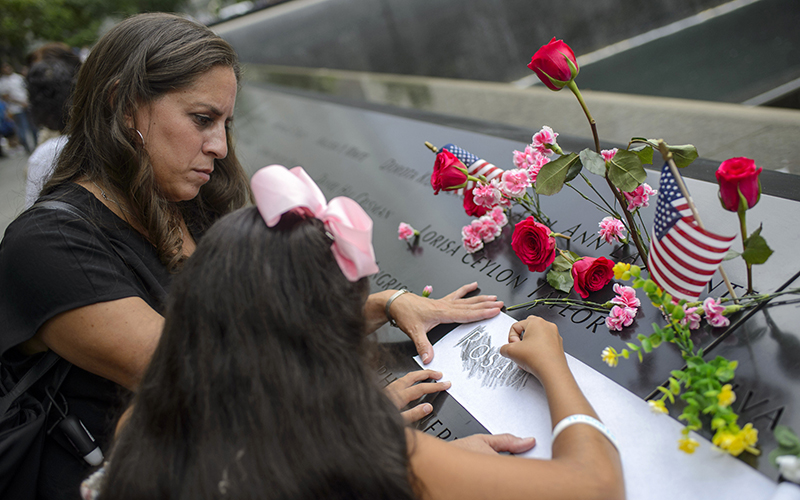 Family of a Sept. 11 victim etch her name onto paper