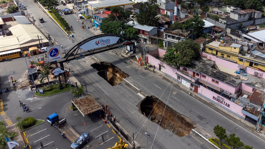 A sinkhole is exposed on the main road in Villa Nueva, Guatemala