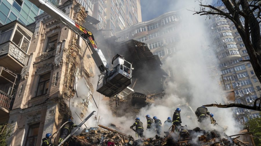 Firefighters work after a drone attack on buildings in Kyiv