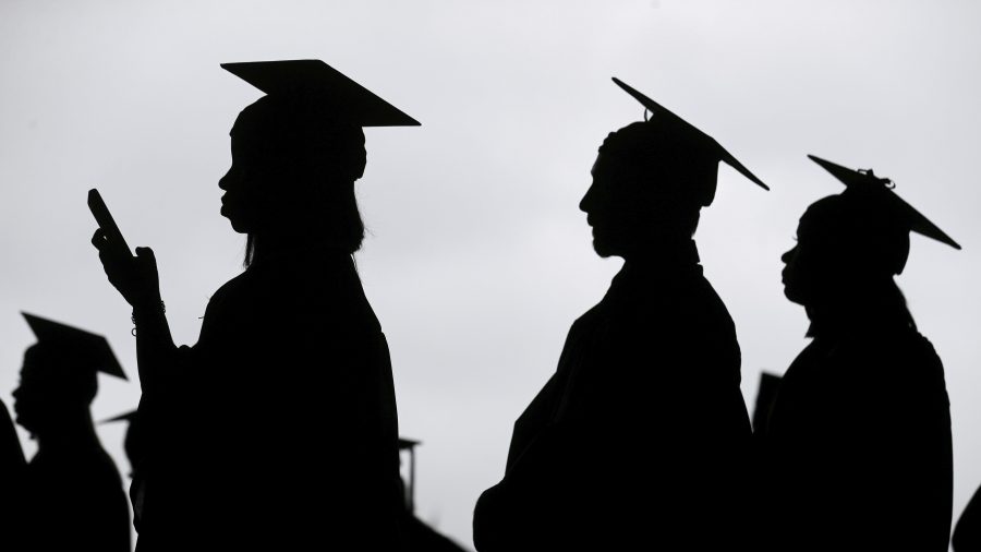 New graduates line up before the start of a community college commencement in East Rutherford, N.J., May 17, 2018. A federal judge in St. Louis on Thursday, Oct. 20, 2022, dismissed an effort by six Republican-led states to block the Biden administration's plan to forgive student loan debt for tens of millions of Americans. (AP Photo/Seth Wenig, File)