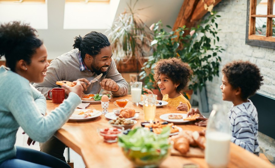 Family eats breakfast together.