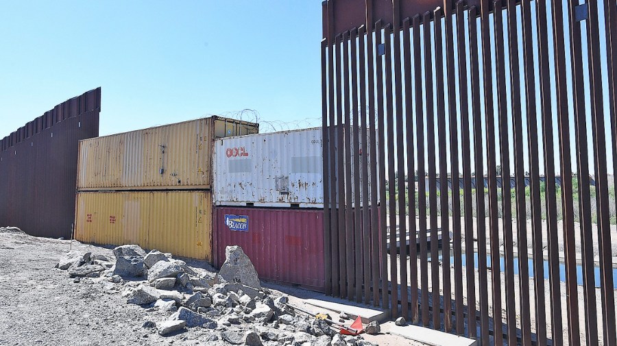 File photo - Shipping containers stacked two high fill a gap in the 30-foot-high bollard border fence near the Yuma Levee Road and Morelos Dam, Friday afternoon, Oct. 14, 2022, near Yuma, Ariz., where migrants could cross into the United States.