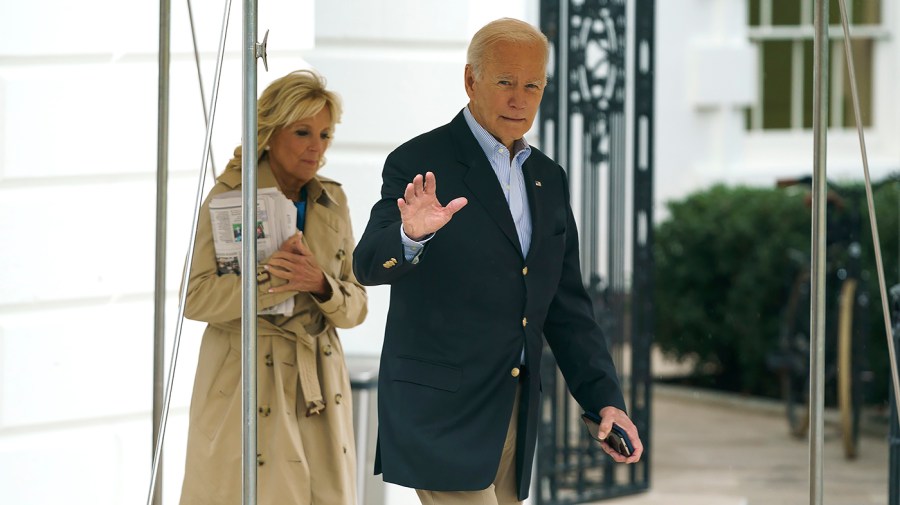 President Biden waves to the press as first lady Jill Biden and the President walk towards Maine One