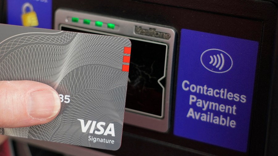 A customer uses the contactless payment chip in a VISA card