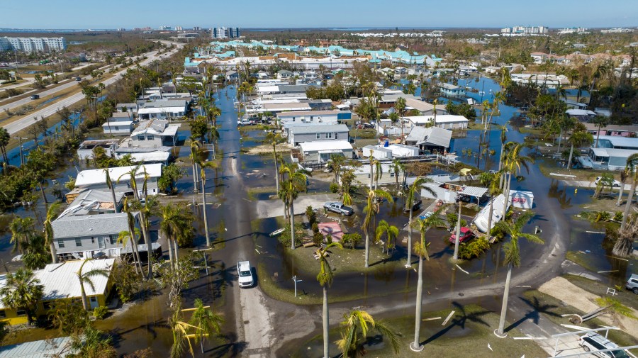 Water floods a damaged trailer park in Fort Myers, Fla.