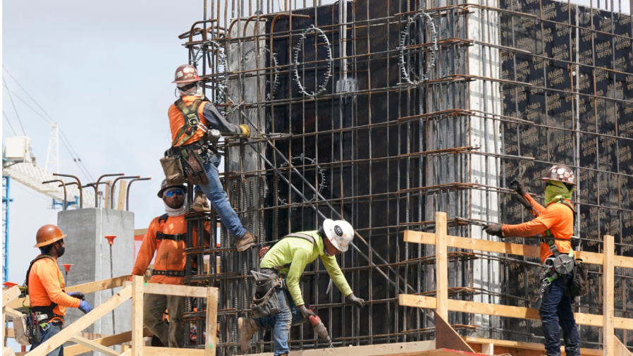 FILE - Construction workers fasten the frame of a new building, Monday, May 3, 2021, in Miami.