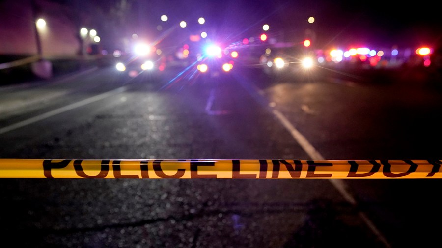 A police tape blocks a road near the scene where a Sacramento County Sheriff's deputy was shot