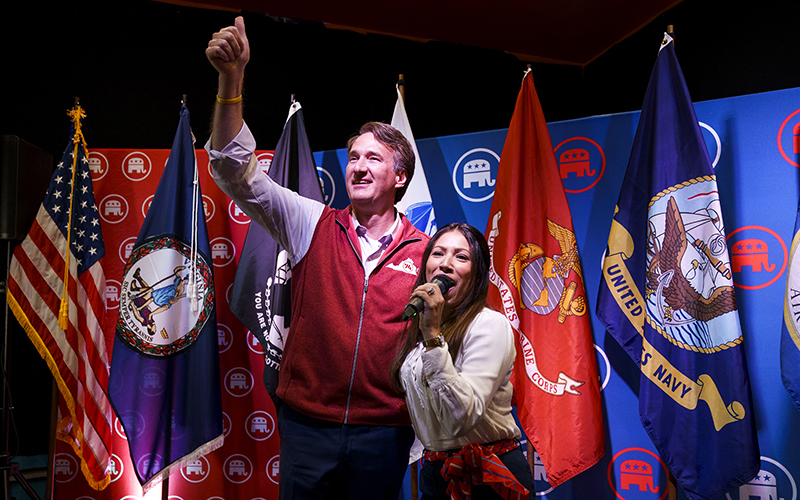 Virginia Gov. Glenn Youngkin, left, gives a thumbs up as he is introduced by Yesli Vega, right