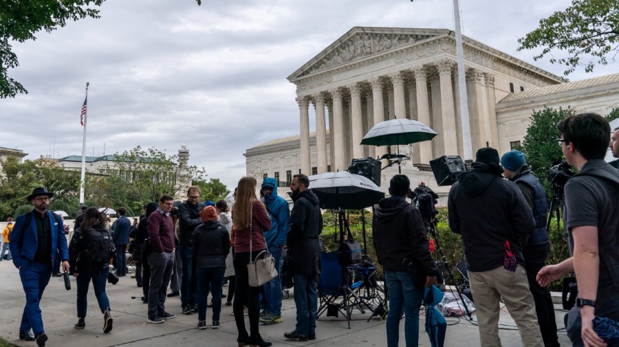 People gather as the Supreme Court begins its new term and to hear the first arguments, on Capitol Hill in Washington, Monday, Oct. 3, 2022.