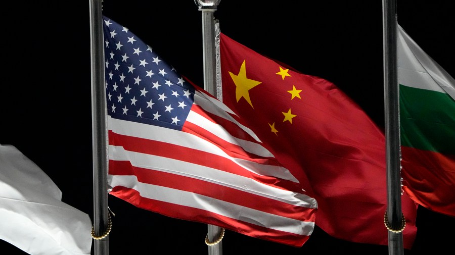 The American and Chinese flags wave