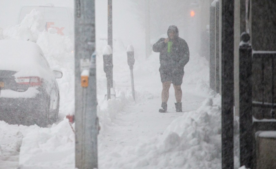 A person walks through downtown in the snow Friday, Nov. 18, 2022, in Buffalo, N.Y.