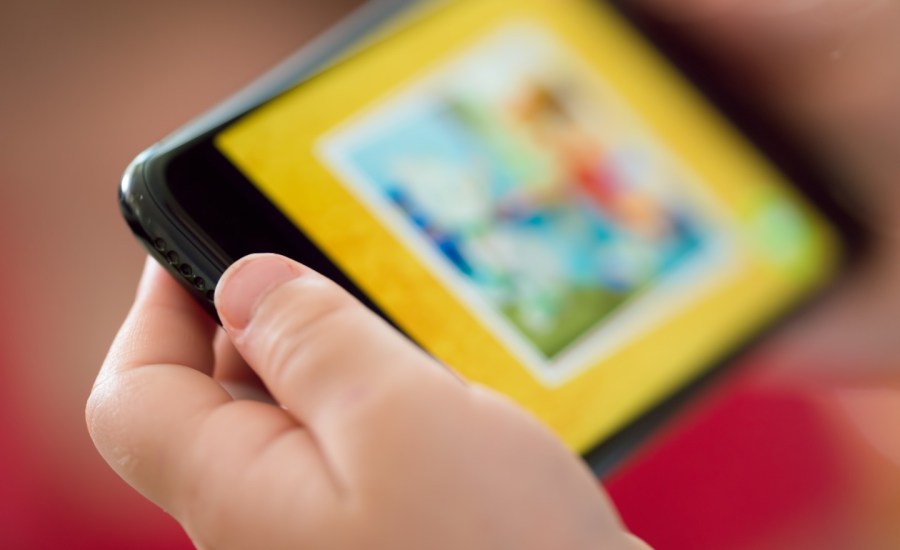 Girl holding device with screen.