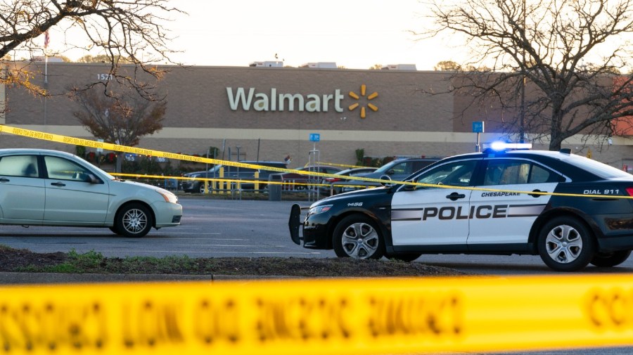 Law enforcement work the scene of a mass shooting at a Walmart, Wednesday, Nov. 23, 2022, in Chesapeake, Va. The store was busy just before the shooting Tuesday night with people stocking up ahead of the Thanksgiving holiday.