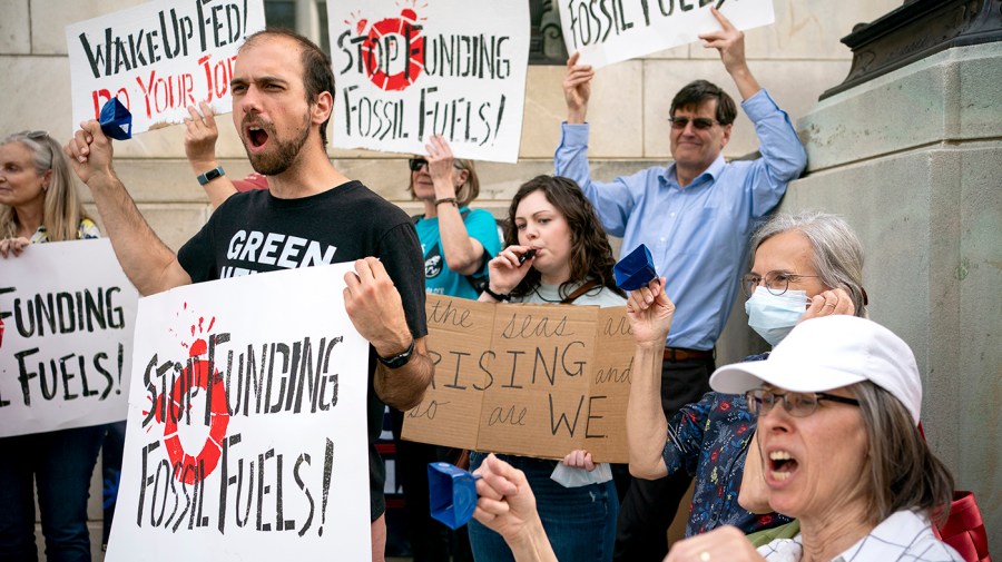 Protesters demonstrate outside the Federal Reserve on Earth Day