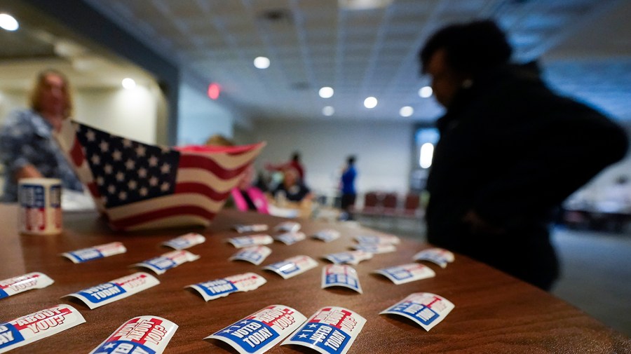 Stickers are displayed on a table for voters