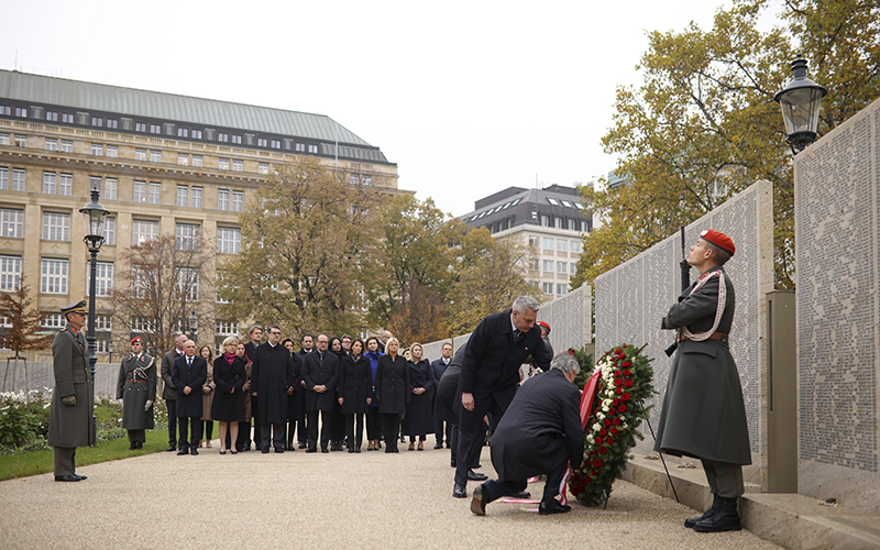 Austria's Chancellor Karl Nehammer, left, and Vice Chancellor Werner Kogler lay down a wreath to commemorate the victims of the “Night of Broken Glass"