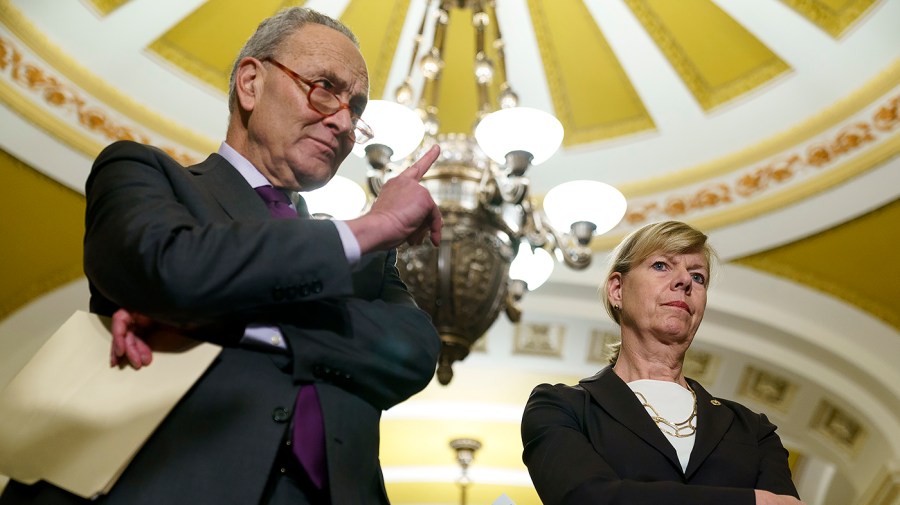 Majority Leader Charles Schumer (D-N.Y.) and Sen. Tammy Baldwin (D-Wis.)