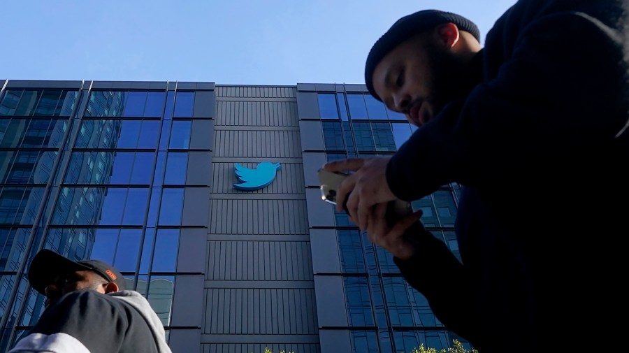 People walk outside Twitter headquarters