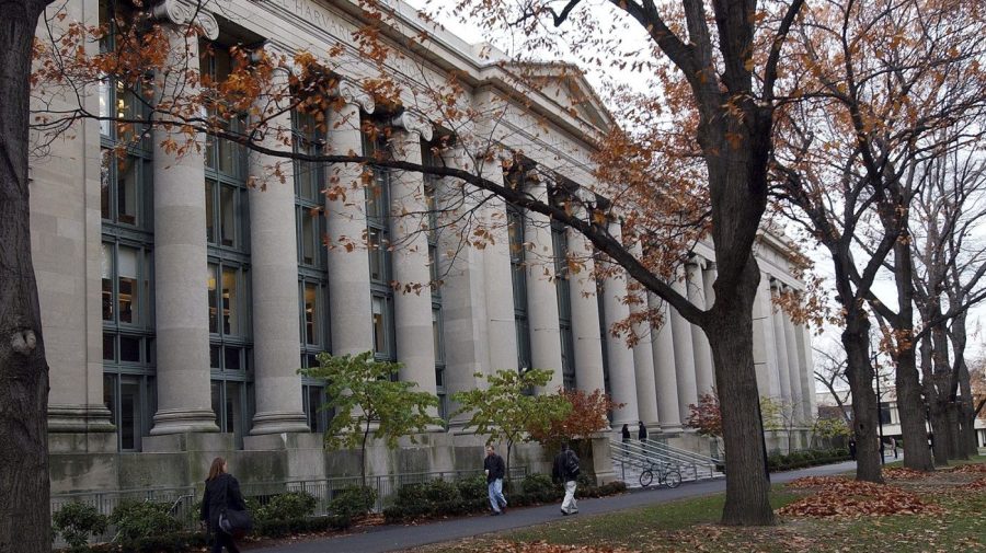 Students walk through the Harvard Law School area on the campus of Harvard University in Cambridge, Mass.