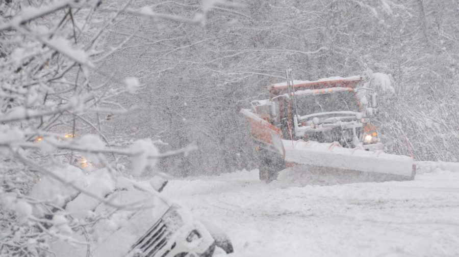 A state plow truck clears snow