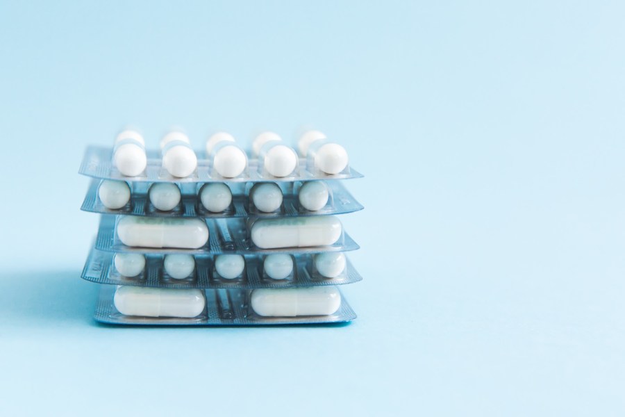 blister packs of pills on a blue background