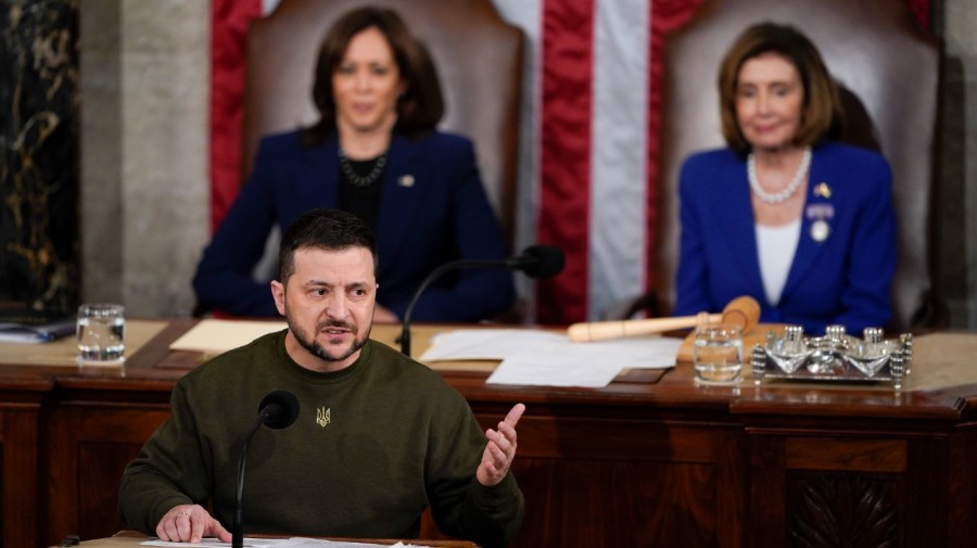 Ukrainian President Volodymyr Zelenskyy addresses a joint meeting of Congress on Capitol Hill in Washington, Wednesday, Dec. 21, 2022. Vice President Kamala Harris and Speaker of the House Nancy Pelosi, D-Calif., right, listen.