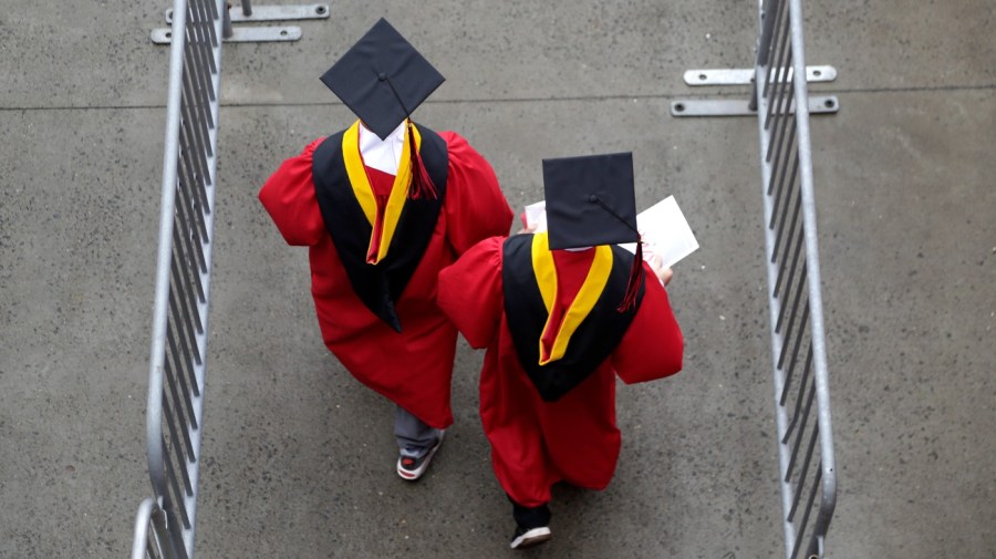 New graduates walk into the High Point Solutions Stadium before the start of the Rutgers University graduation ceremony in Piscataway Township, N.J.