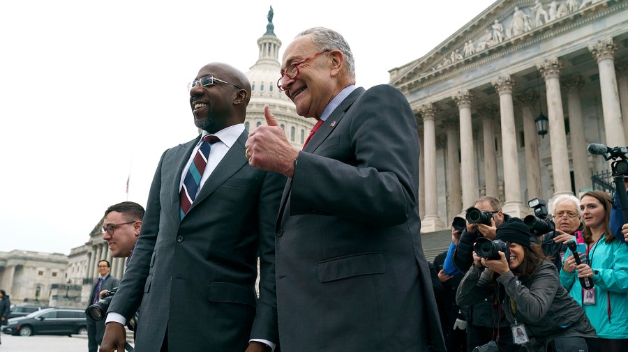 Sen. Raphael Warnock (D-Ga.) and Majority Leader Charles Schumer (D-N.Y.)