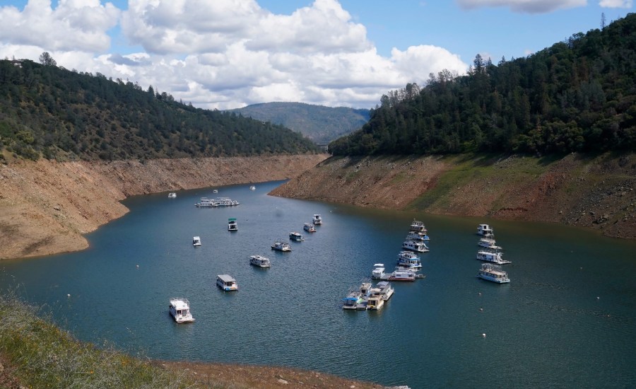 Houseboats sit in the drought lowered waters of Oroville Lake, near Oroville, Calif., Tuesday, April 19, 2022.