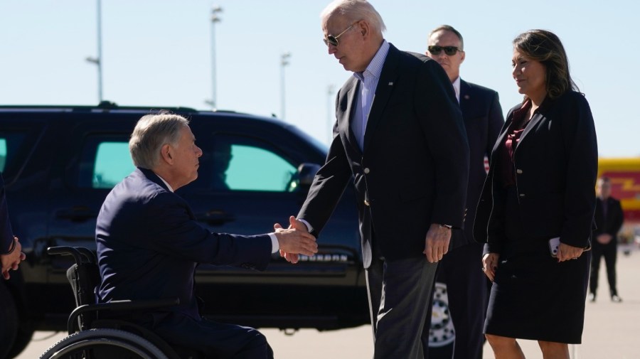 President Biden shakes hands with Texas Governor Greg Abbott.