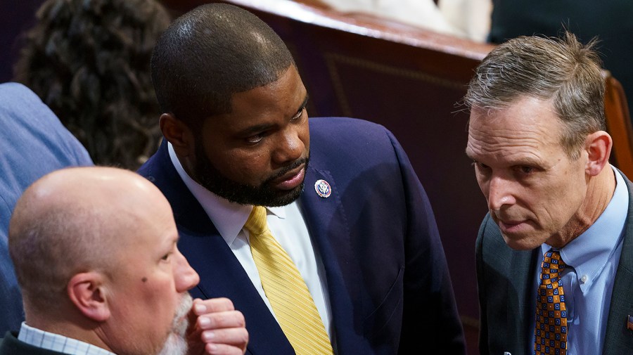 Rep. Byron Donalds (R-Fla.) speaks with Reps. Chip Roy (R-Texas) and Scott Perry (R-Pa.)