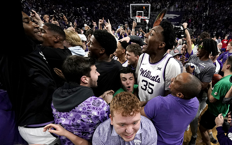 Kansas State forward Nae'Qwan Tomlin celebrates with fans after an NCAA college basketball game