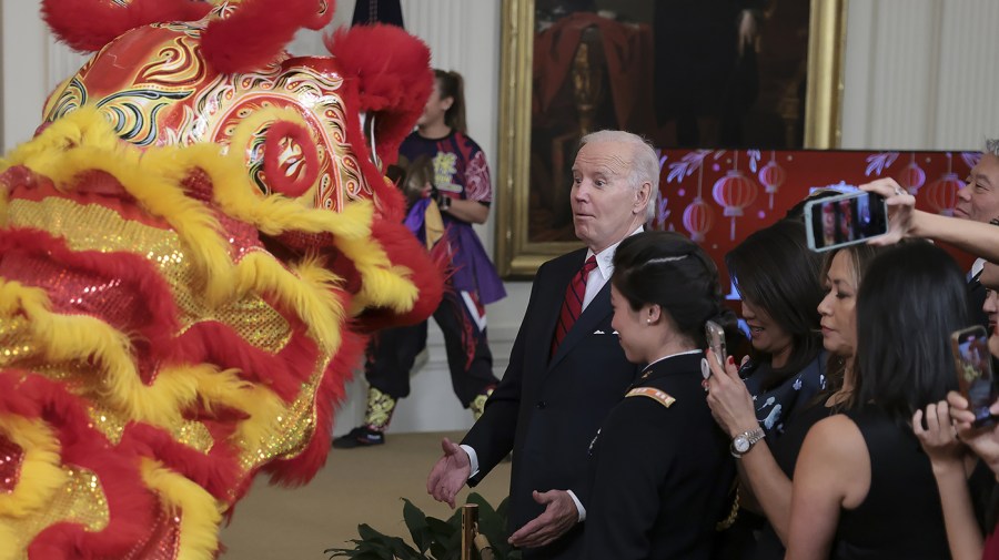 President Biden reacts as members of the Choy Wun Lion Dance Troupe perform during a Lunar New Year Reception in the East Room of the White House on Jan. 26 in Washington, D.C.