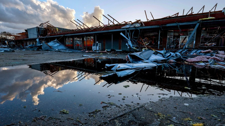 The roof of a local businesses is strewn about after a tornado passed through Selma, Ala.