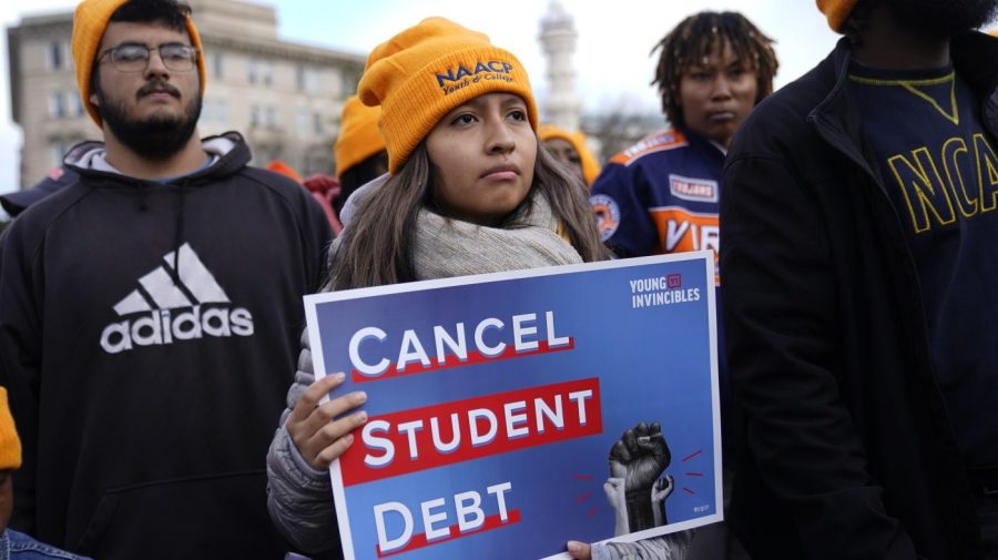 Student debt relief advocates gather outside the Supreme Court