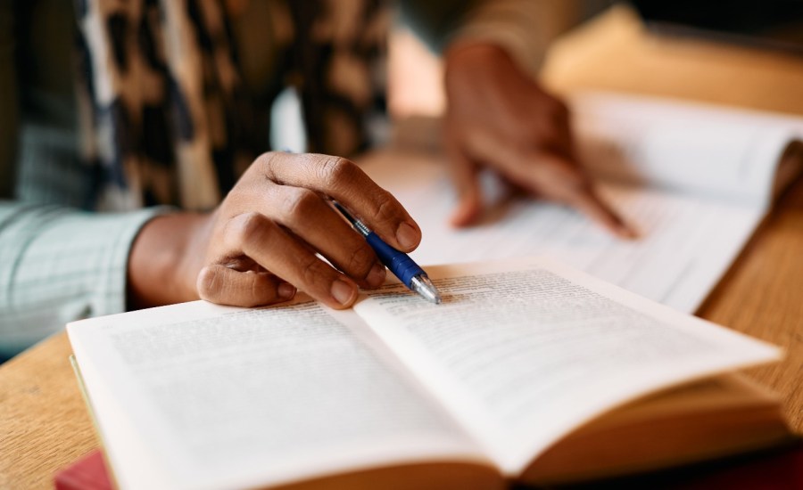 Woman reading textbook.